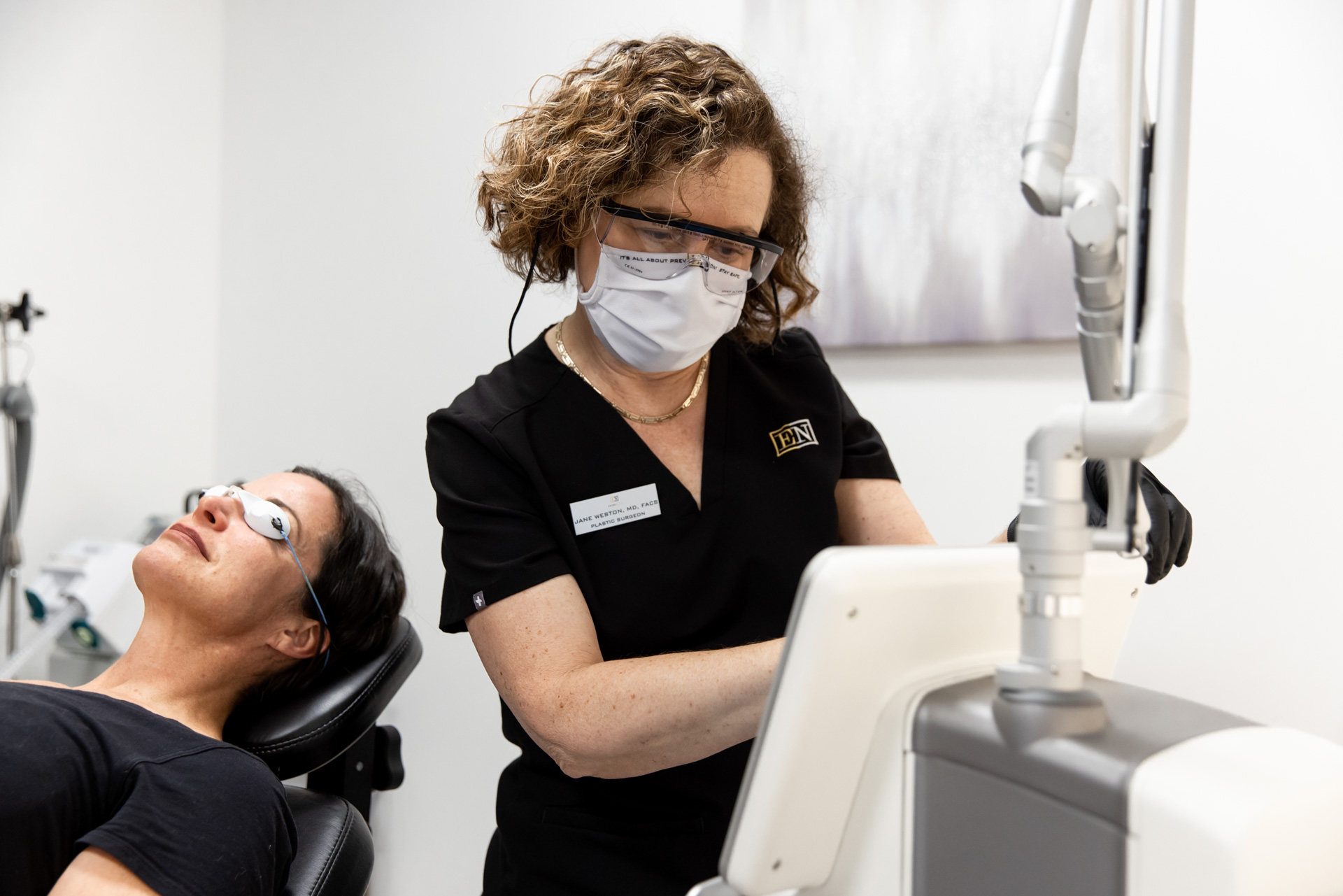 Dr. Weston performing a laser face treatment in Menlo Park