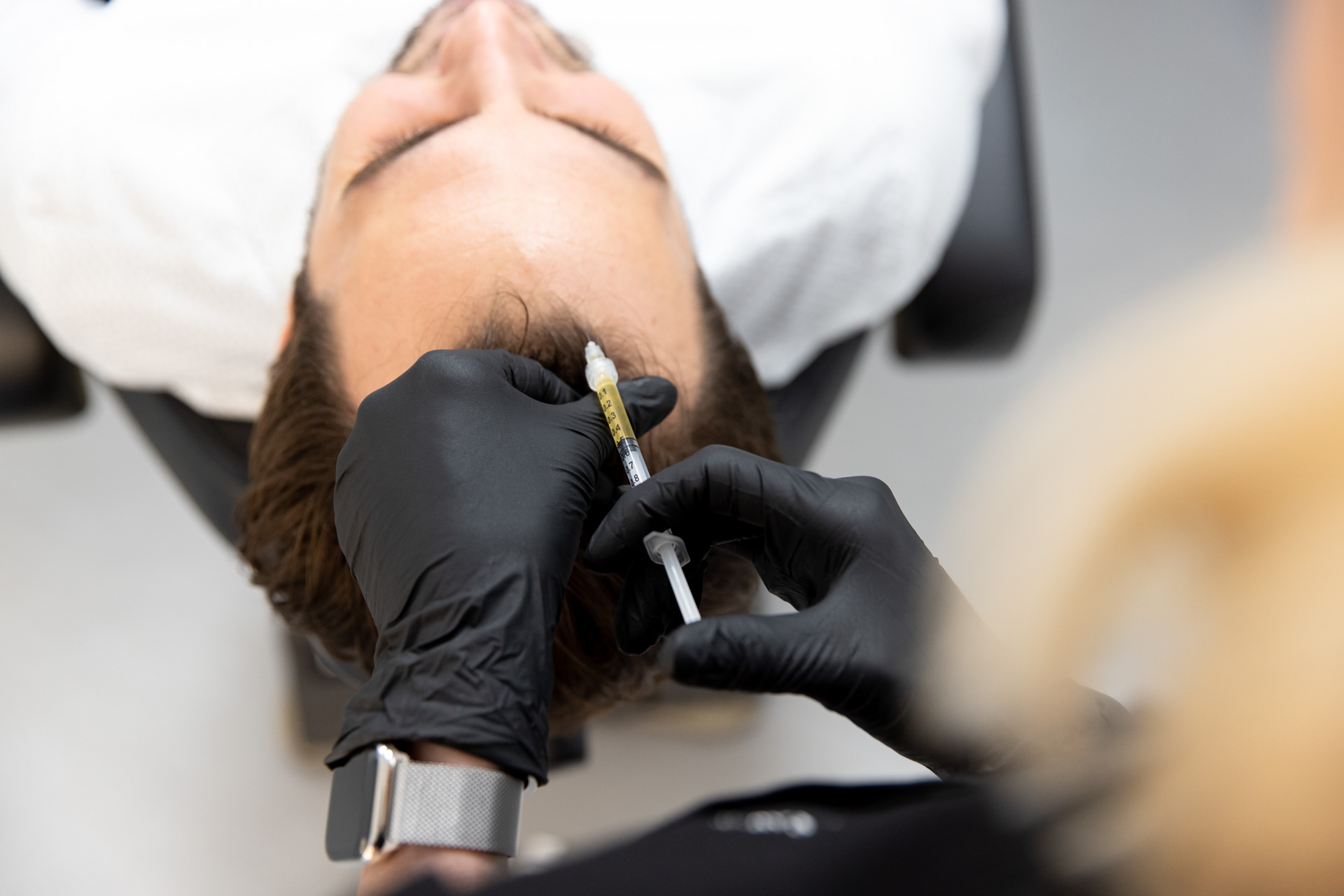 A man gets an injection of PRP at his hair restoration clinic in Menlo Park