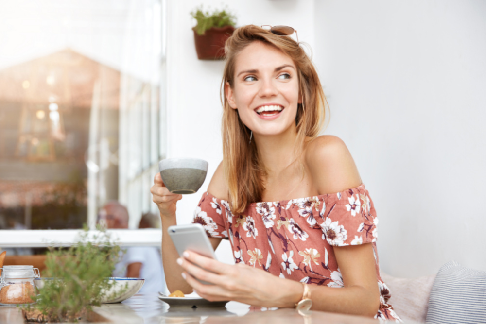 woman smiling enjoying coffee