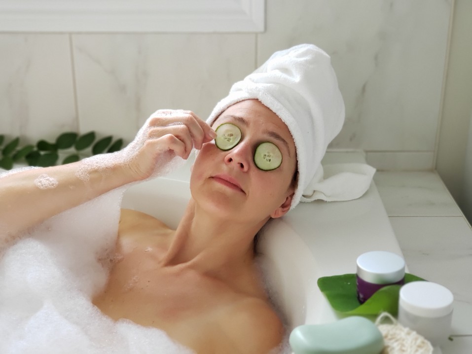 woman in bathtub indulging in personalized skincare